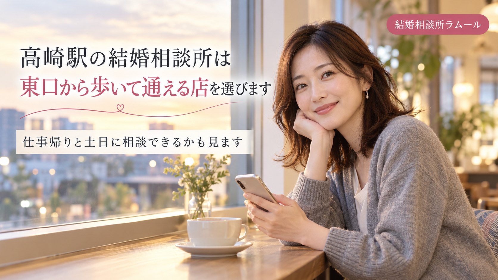 夕方のカフェの窓際でスマホを手にほほえむ34歳の女性（高崎駅の結婚相談所は東口から歩いて通える店を選びます）